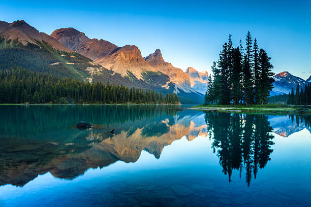 Mountain lake at sunrise reflecting peaks and pines — the internet built for humans